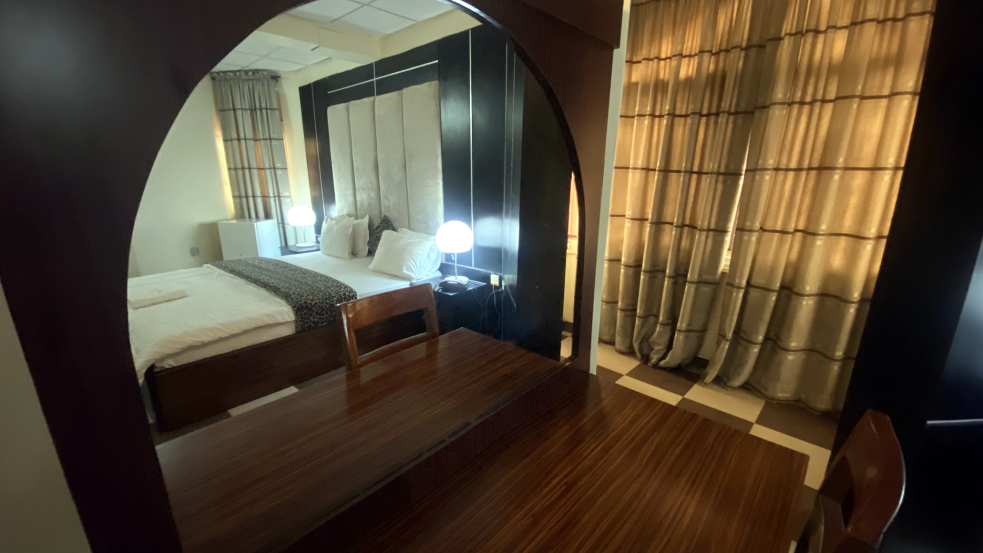 Guest room — bedroom reflected in arched mirror