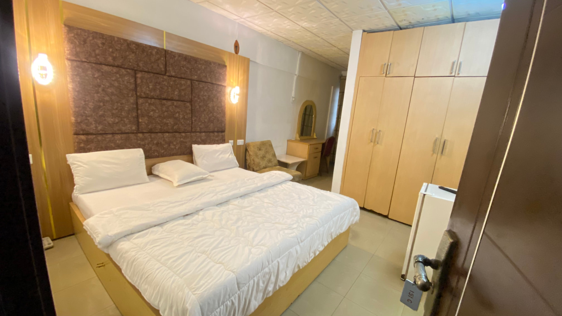 Guest room — large bed, wardrobe and vanity