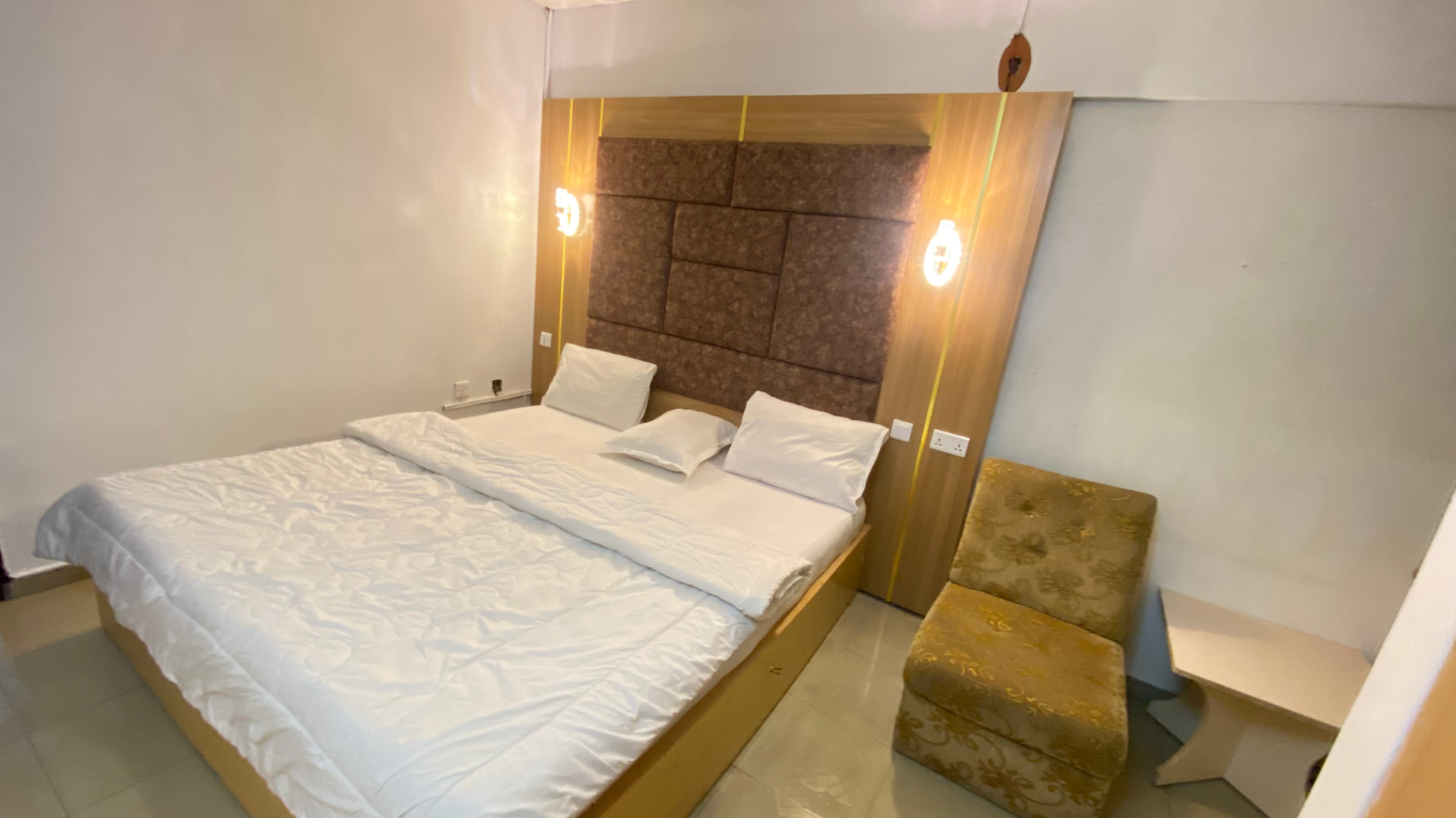 Guest room — large bed and lounge chair